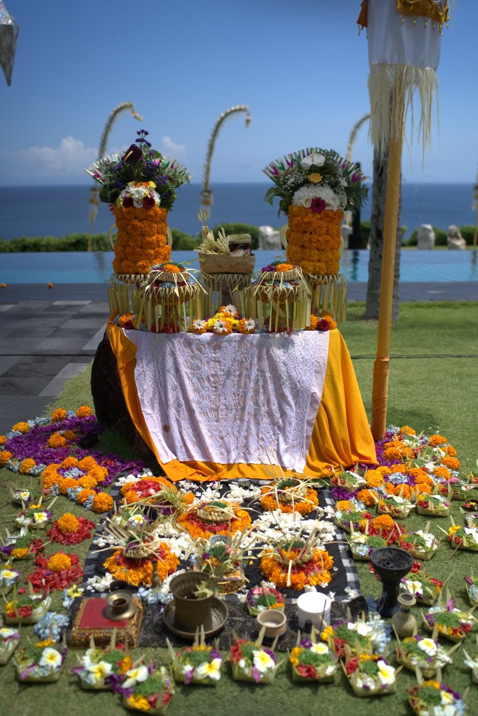 Balinese flower offerings and ceremony overlooking the ocean